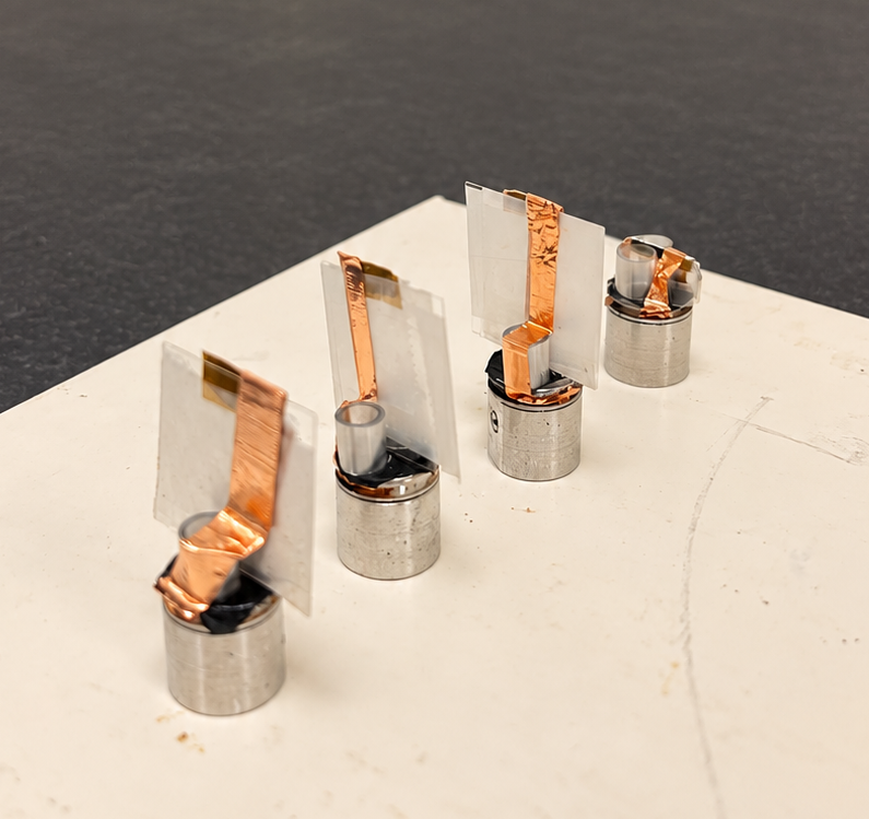 Four samples on a clean lab bench.png