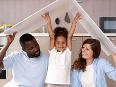 A foster mom and dad holding a roof over their foster child's head.