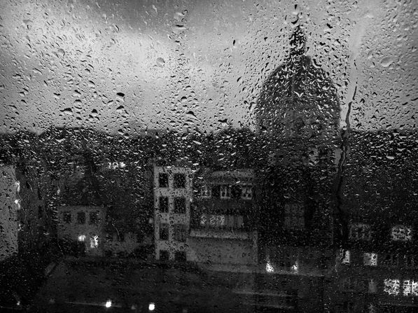 Copenhagen roof tops, iconic church, through rainy wondow