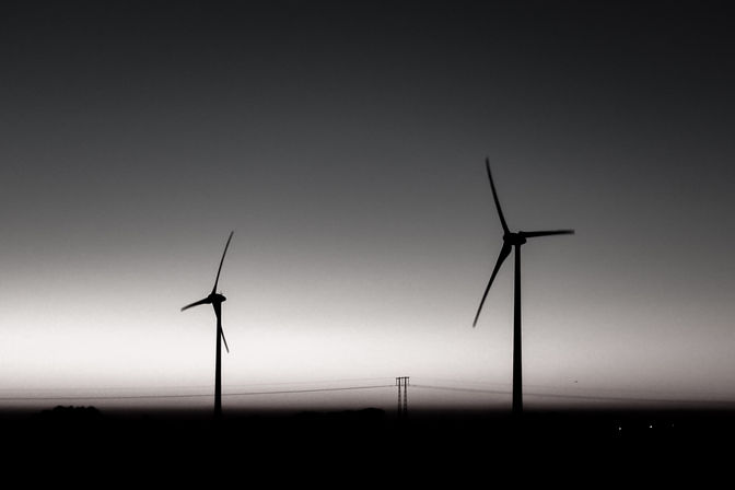 2 windmills in the country side, power lines in the horizon, Skaane, sweden