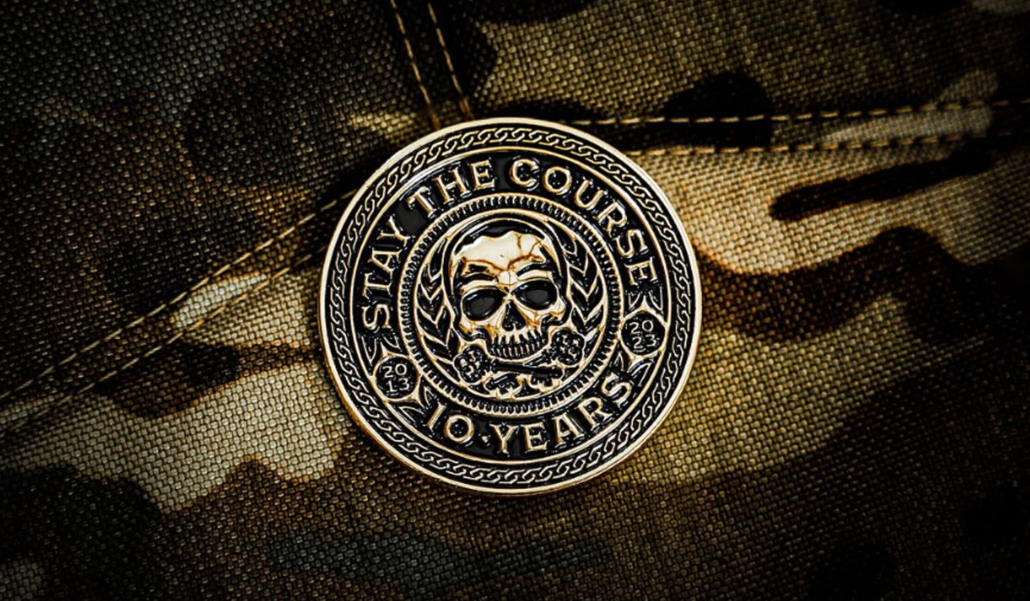 a gold coin with a skull design and the words stay the course and 10 years written around the edge. designed by freelance graphic designer Stephen Williams