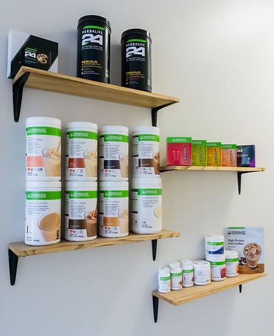 product shelf of Herbalife protein tea and supplements