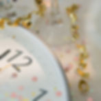 Clock showing twelve streamers and confetti
