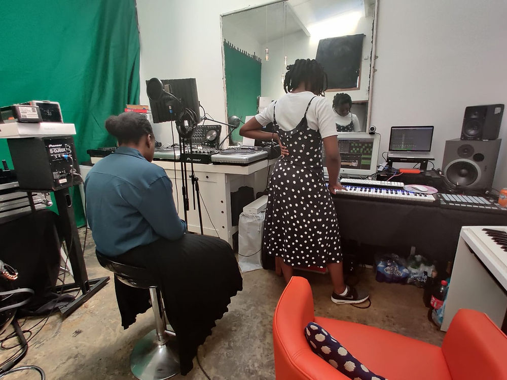 Two people in a music studio with recording equipment