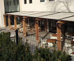 awnings over a restaurant seating area VU Window Treatments