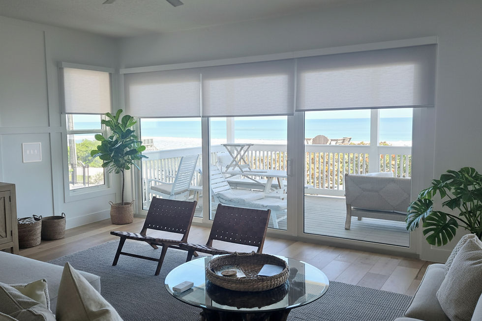 A cozy Florida living room overlooks the beach from windows with motorized window shades - vu window treatments, FL