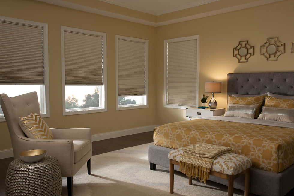 An elegant bedroom in yellow and gold tones has honeycomb shades on the windows - vu windows-treatments, fl