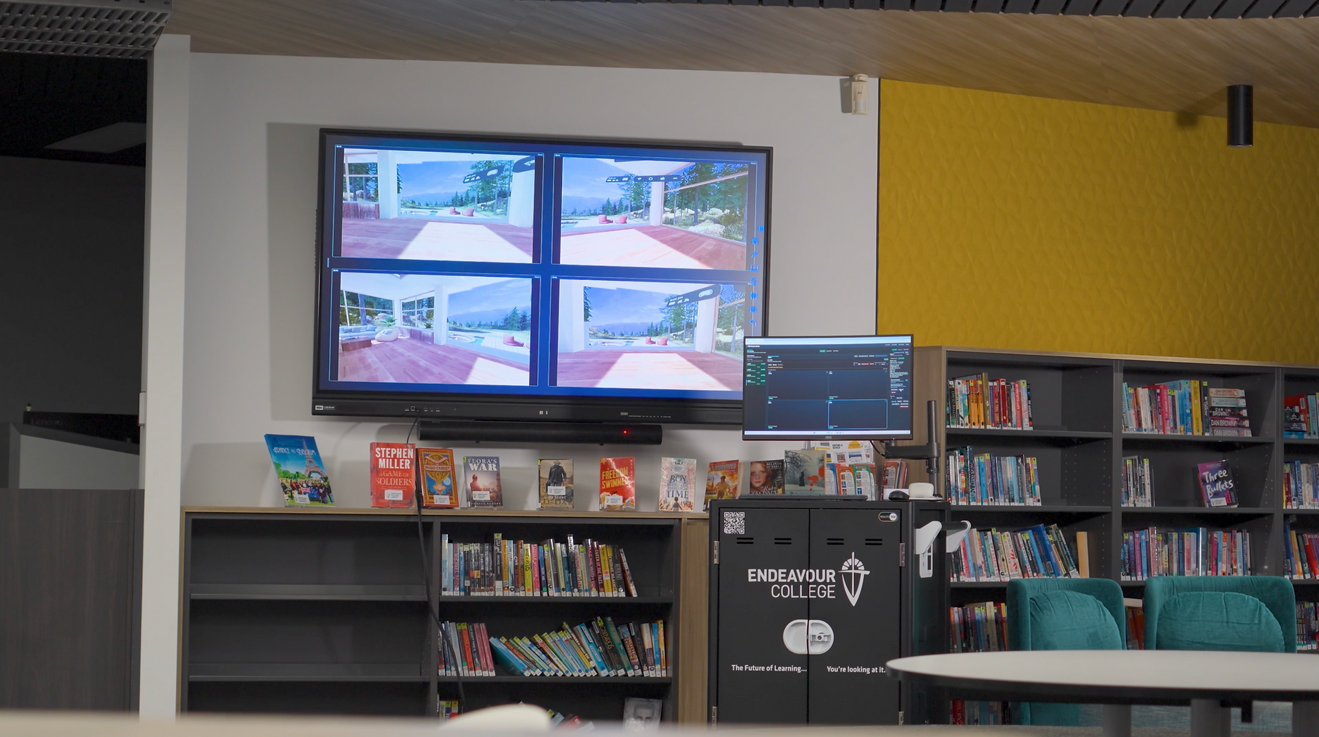 Endeavour College library with digital screen and bookshelves.