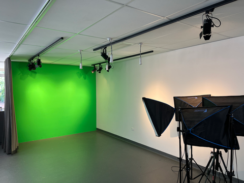 Green screen studio setup with lighting equipment and camera rig
