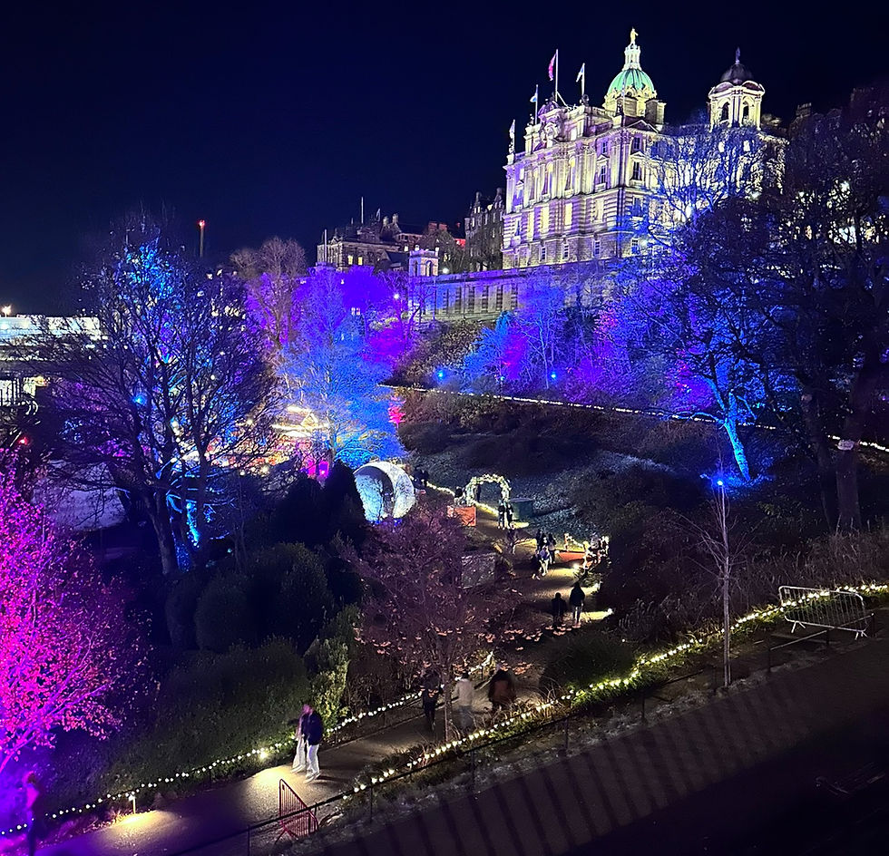 A view of the royal mile from the Christmas market. The light garden is on display on a quiet and dark Edinburgh evening.