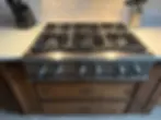 Technician repairing cooktop in Denver kitchen