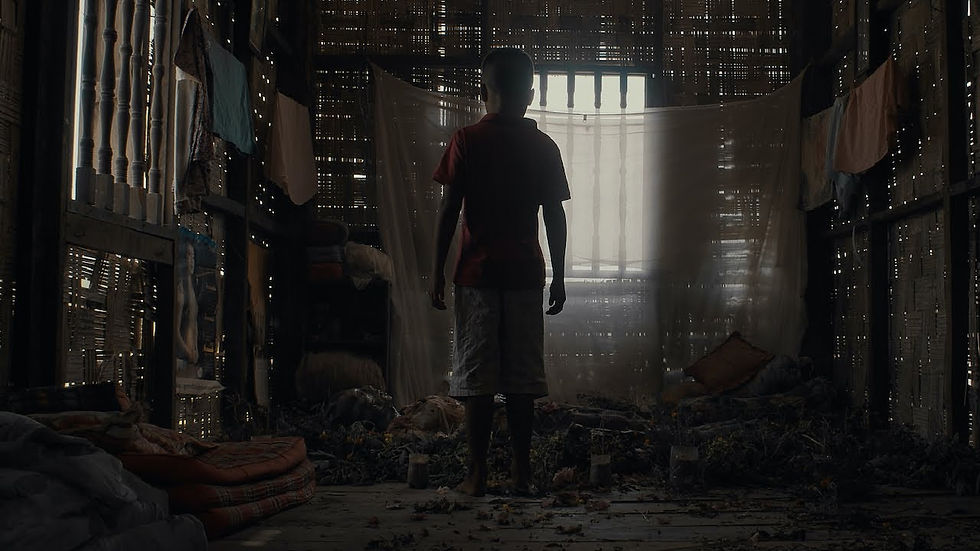 The Long Walk: A boy in a village shack stands over the body of a decaying and dead woman.