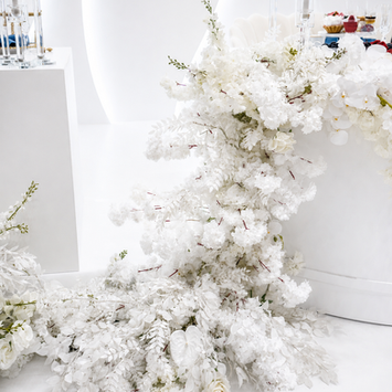 Wedding Stage with white flowers on the side.
