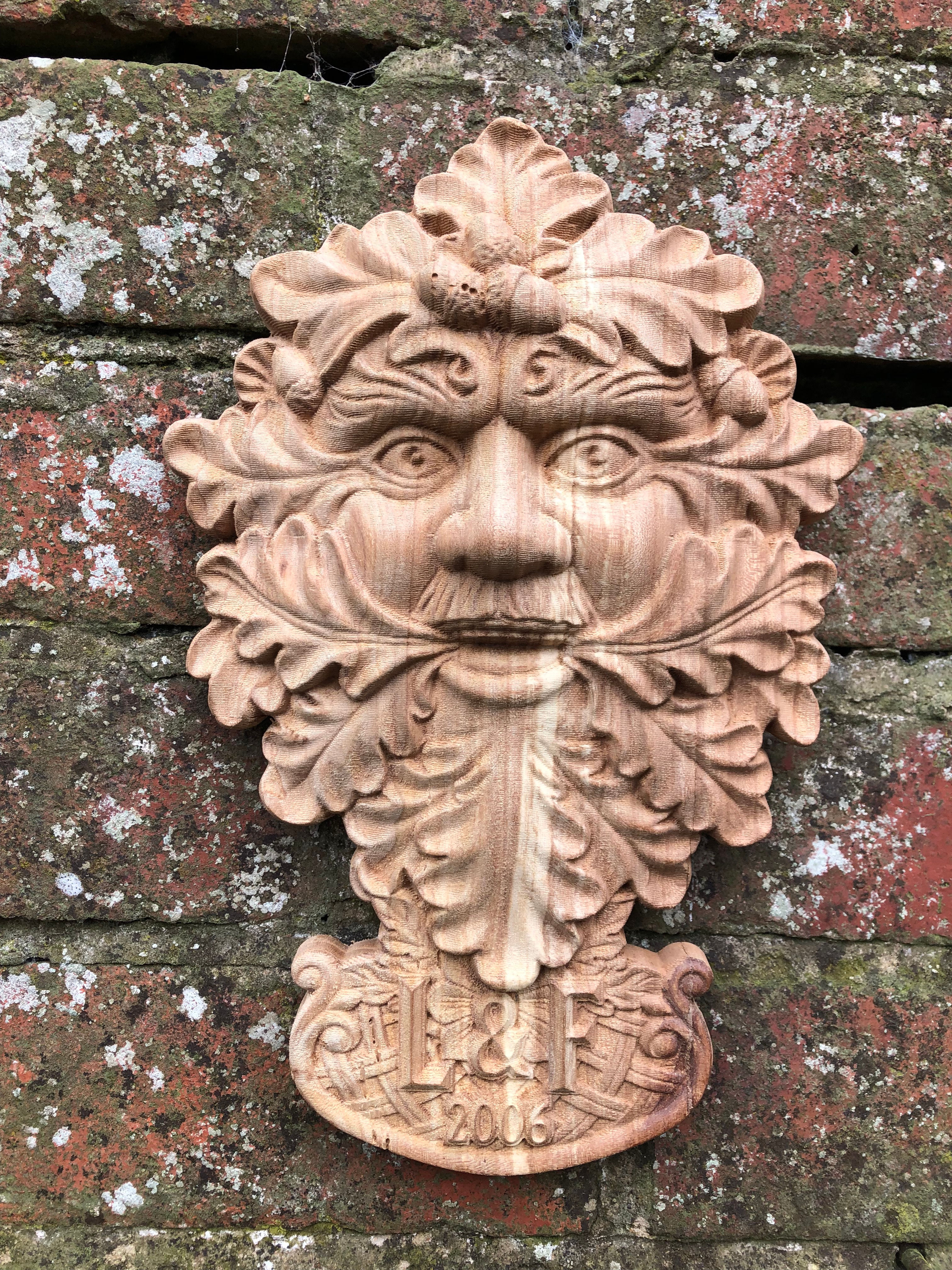 Front view of the Solid Oak Green Man sculpture, showcasing intricate details and natural oak grain.