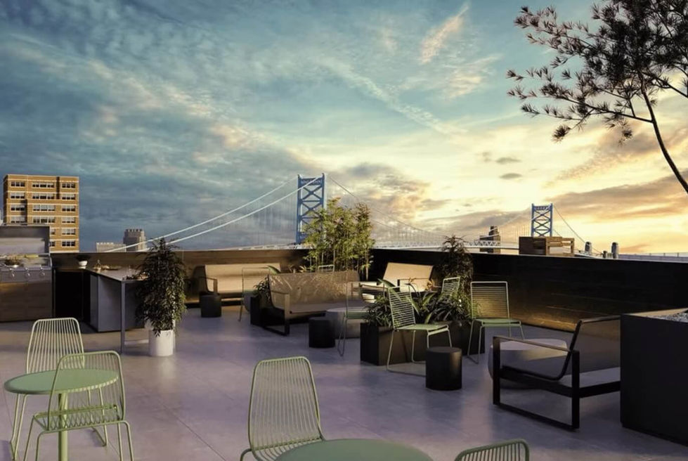 rooftop lounge area at sunset with a view of the bridge in the distance
