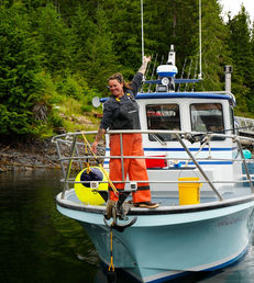 A female fisherman celebrating upon her return to the lodge from a full day of the best deep sea fishing in Alaska