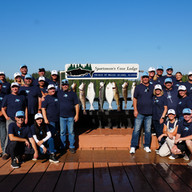 A group photo of employees all form the same company at Sportsman's Cove Lodge on a corporate retreat