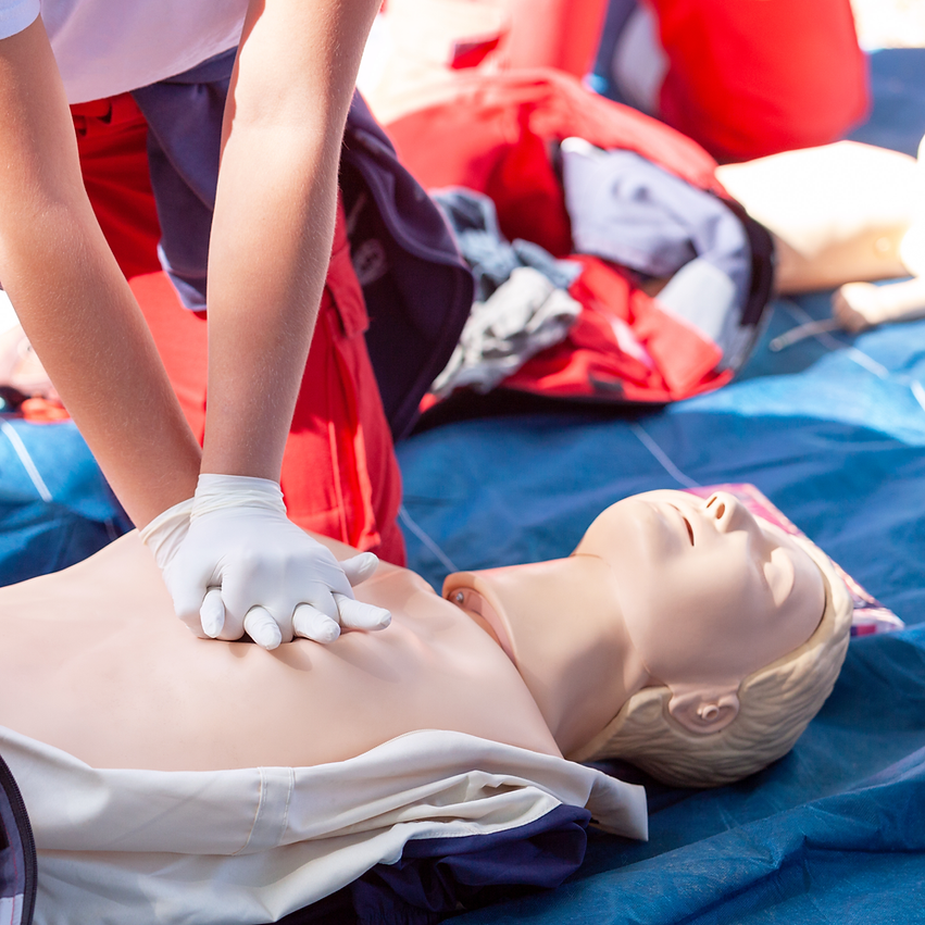 Person performing CPR on a training mannequin
