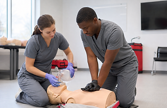 Medical students practicing CPR on a training mannequin