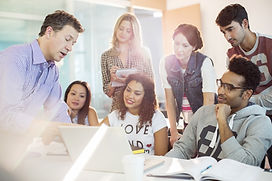 Students meeting with a professor around a computer