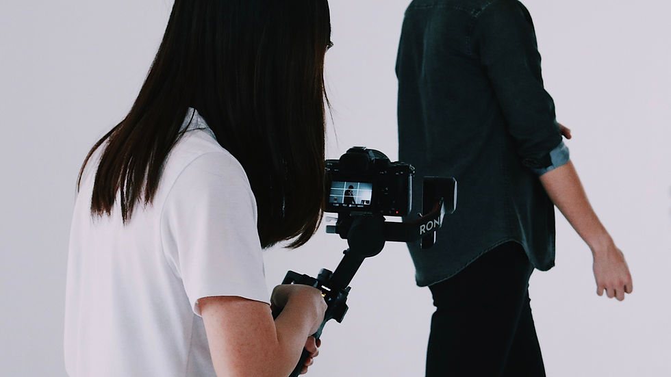 Founder Stephanie (Tung) holding a gimbal while shooting video for TON Studio