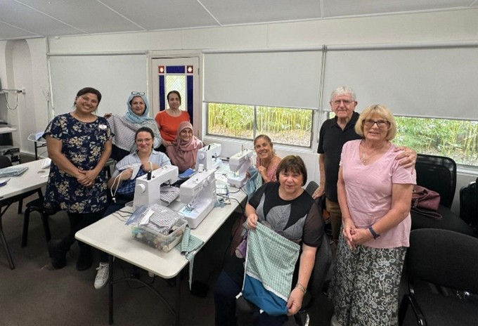 Tony & Sandra Castley from SewAid presenting sewing machines to the group