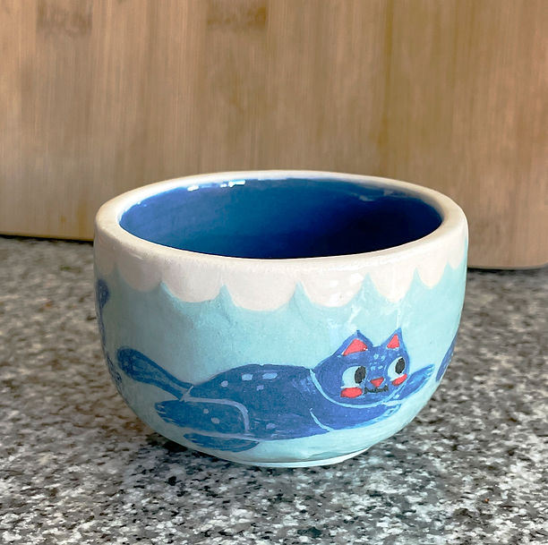Ceramic plate of cute and blue cats swimming