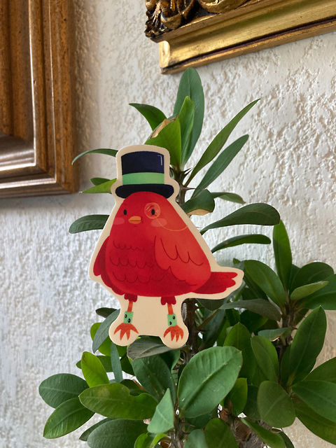 Sticker design of a red bird with top hat, very elegant and fancy. 