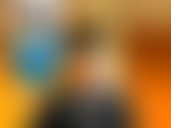 Graduate in cap and gown holding blue star balloon with "You’re #1" text. Wearing "My Big Day" badge. Wooden doors in background.