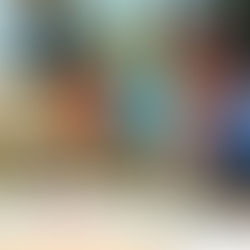 Group on podium with medals at Special Olympics SoCal, smiling and giving thumbs up. Colorful flags and palm trees in the background.