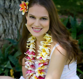 Smiling woman wearing lei and flower