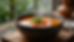 Close-up of a steaming bowl of vegetable soup on a wooden table