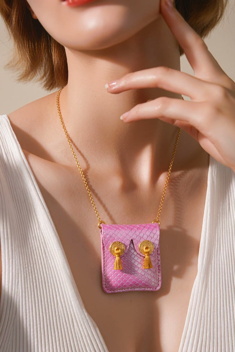 Thumbnail: Iridescent pink snake skin vegan  boob purse necklace with gold nipple tassels