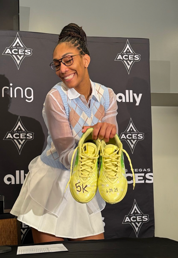 A'ja Wilson holds a pair of her "Princess and the Frog" A'Ones with handwritten "5K 6-25-25" to commemorate the date she earned 5000 career points