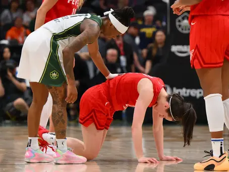 Caitlin Clark on hands and knees during matchup against Seattle Storm. Photo from Clutch Points