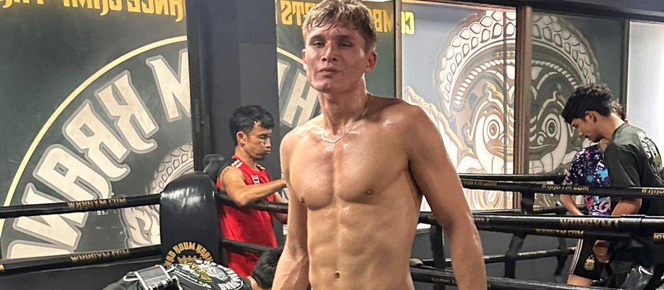 A man standing after a pad session at wkk gym Bangkok