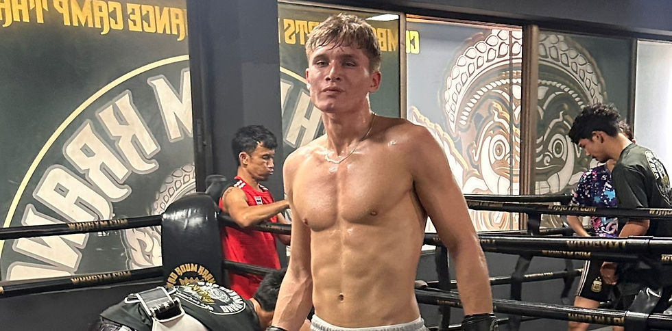 A man standing after a pad session at wkk gym Bangkok