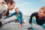 2 ladies being trained by another lady fitness instructor