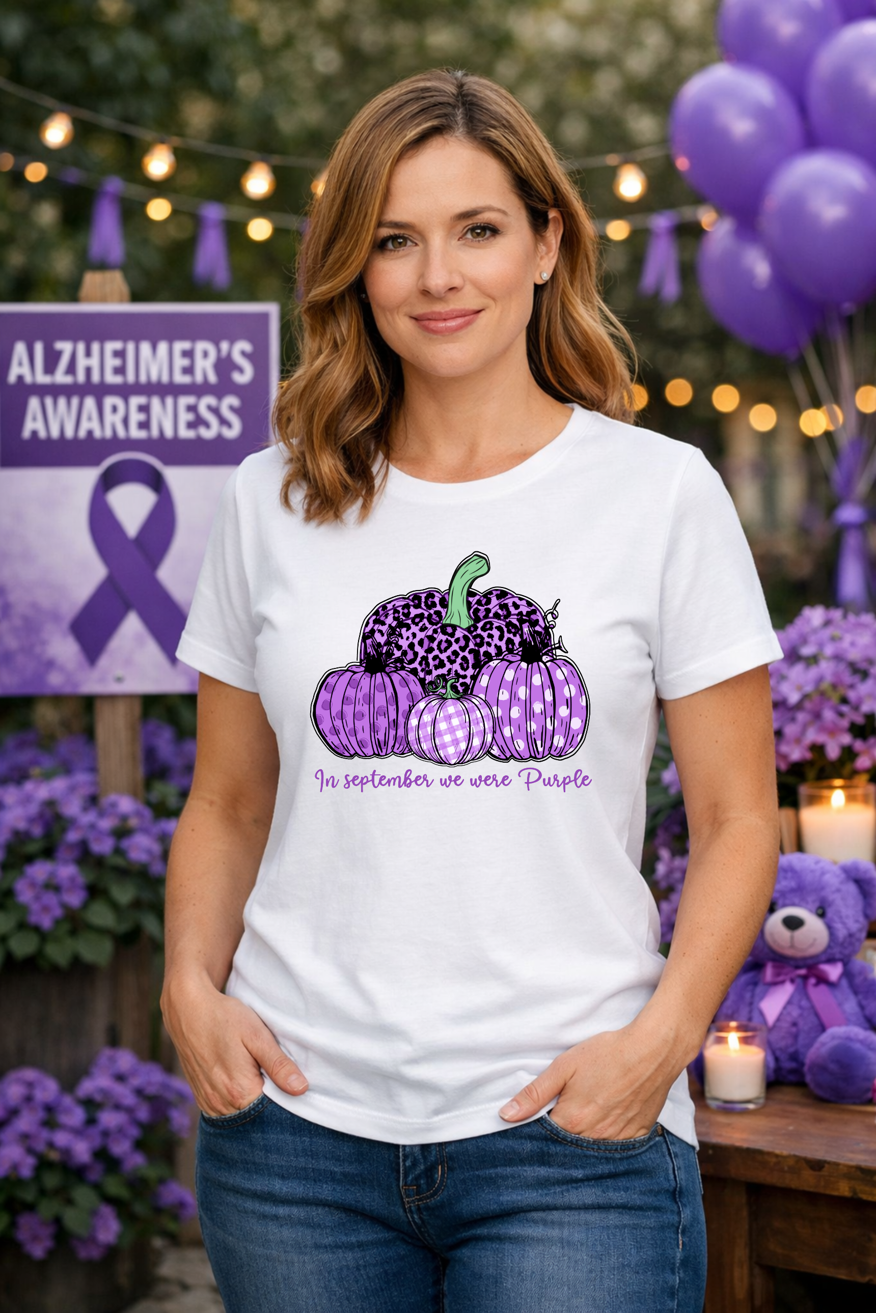A white Alzheimer’s Awareness shirt featuring purple patterned pumpkins and the message “In September We Wear Purple”