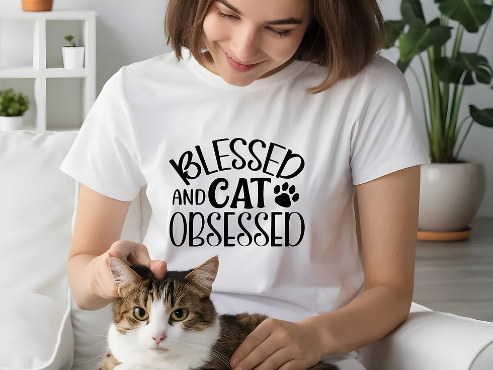 : Woman wearing a white Blessed and Cat Obsessed t-shirt while petting a cat