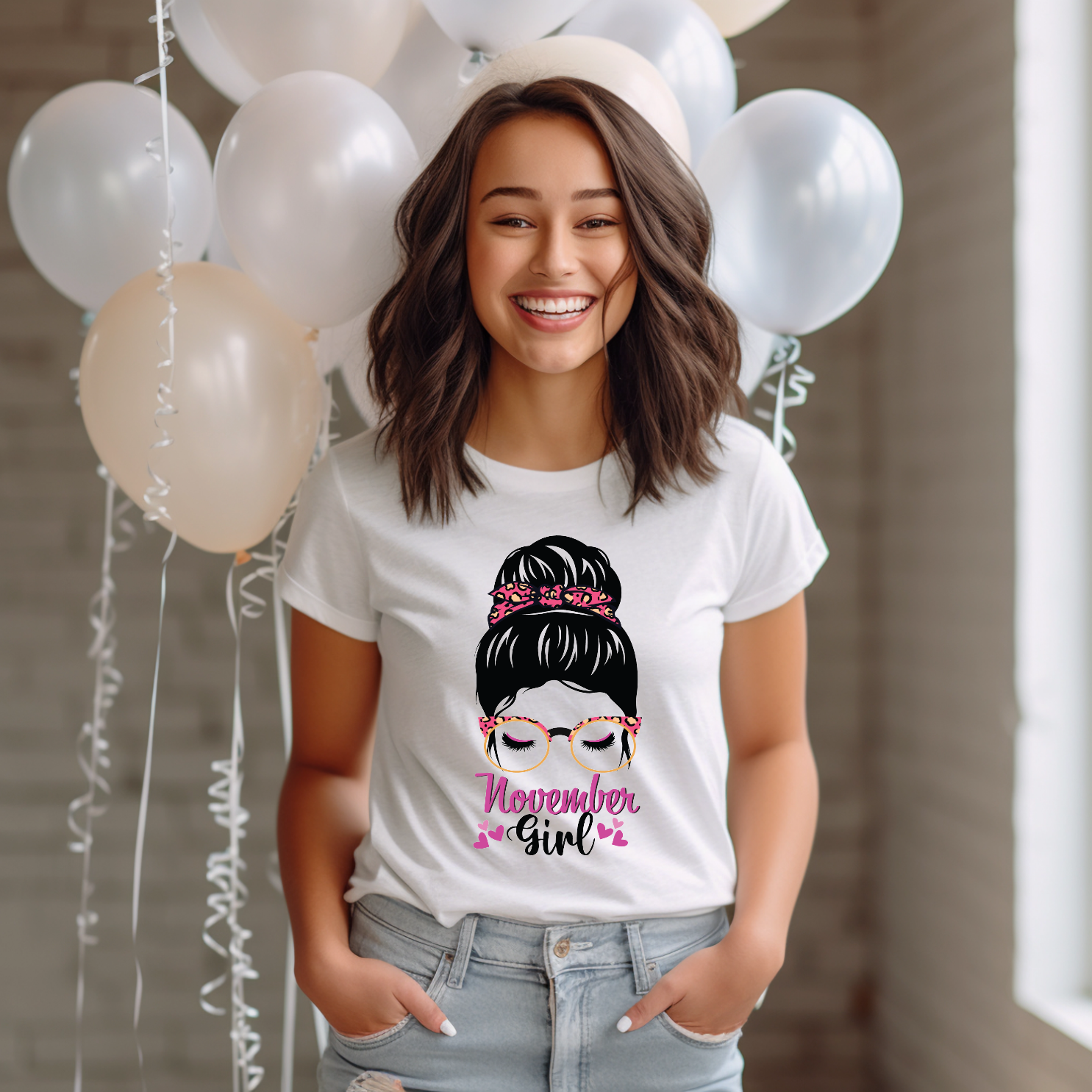 Woman graphic with a messy bun, bright pink leopard bandanna and glasses with hearts above text reading November Girl.
