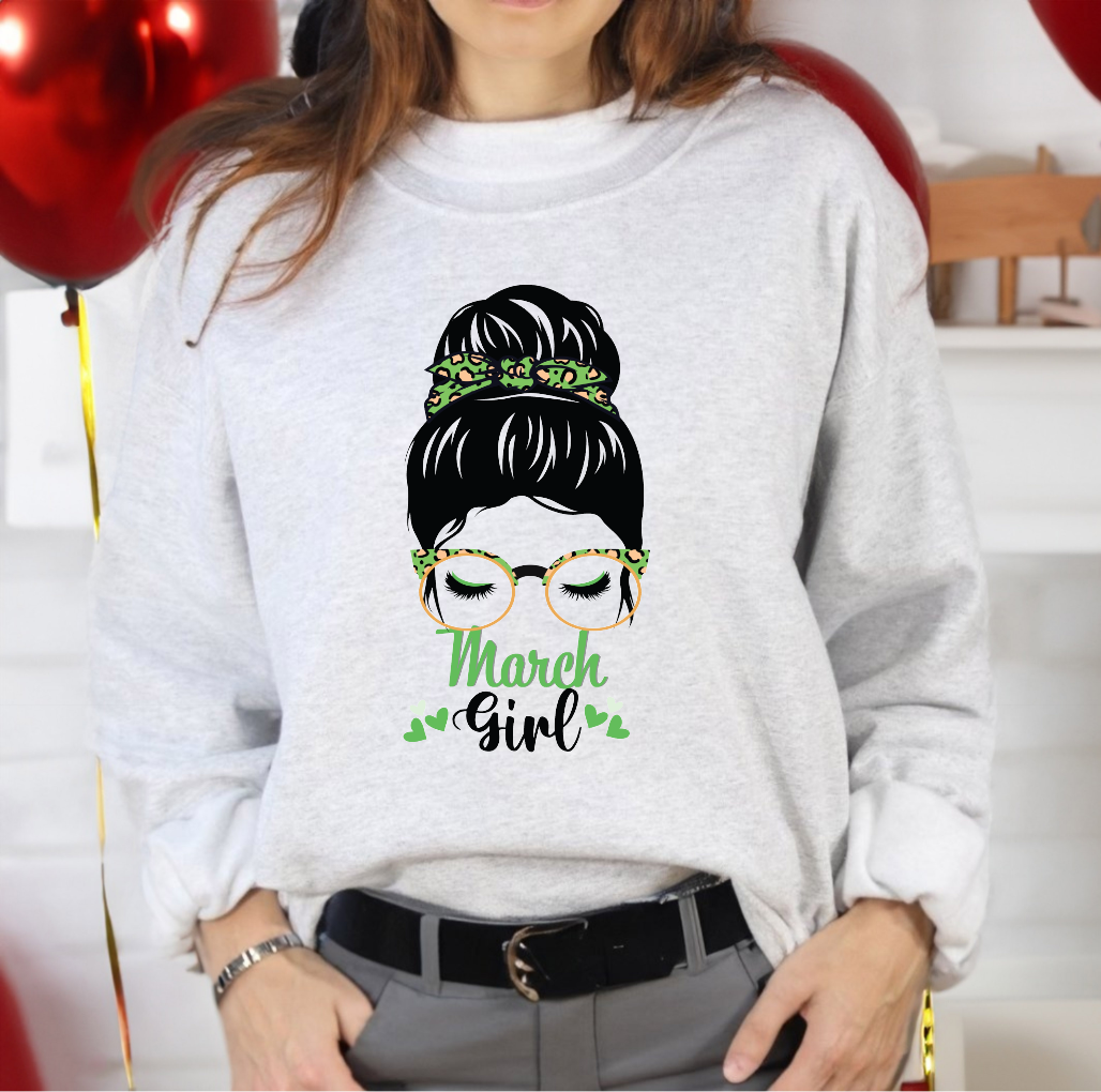 Woman graphic with a messy bun, green leopard print glasses, and small hearts above text reading March Girl.