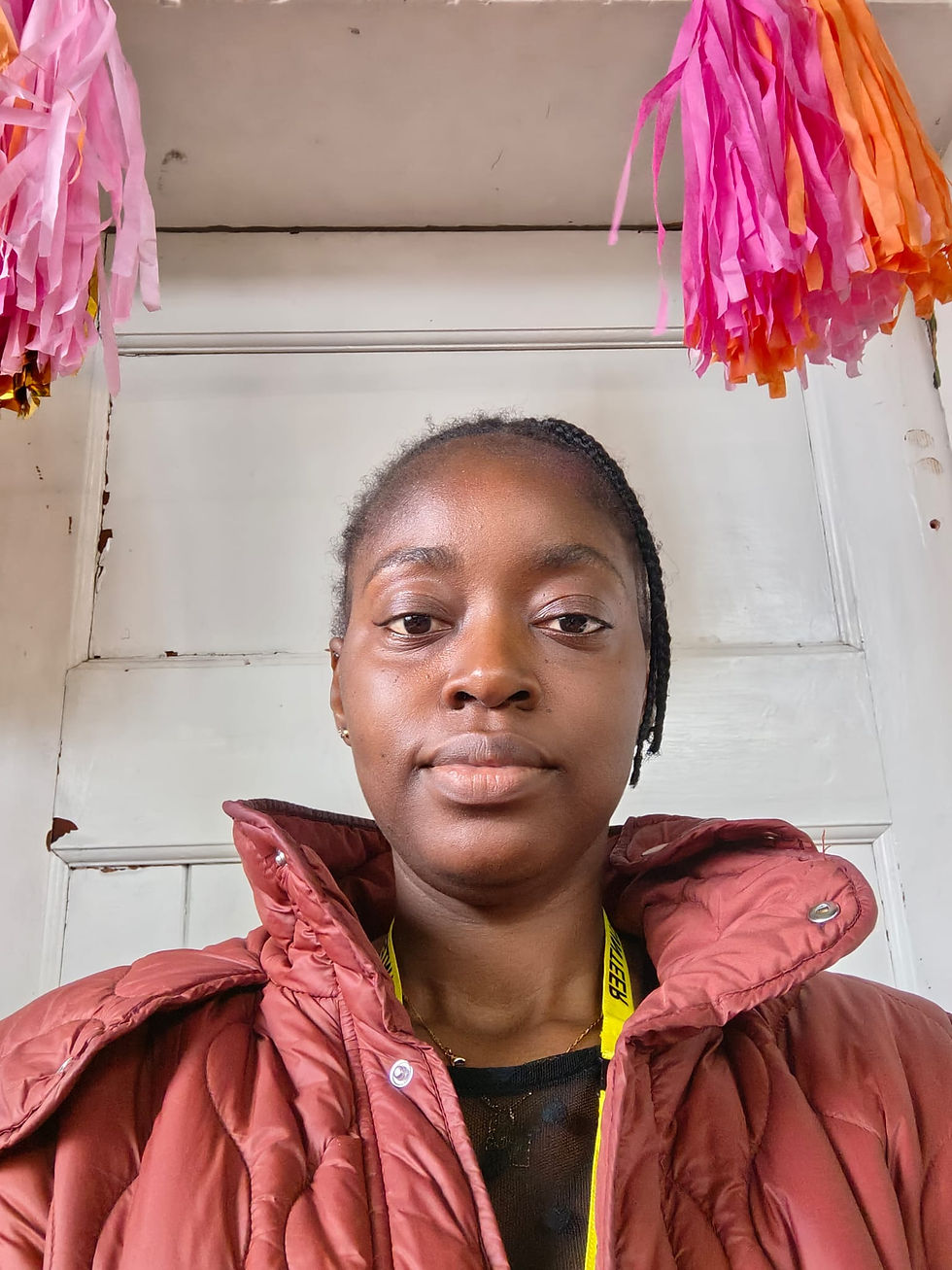 Selfie of Lola in a red jacket and her volunteer lanyard