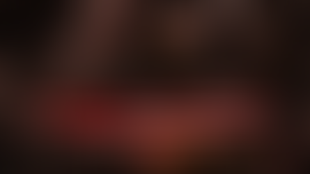 Futuristic robot analyzing data on screens. Text: "Top 10 AI Robotics Companies in 2026." Dark tech environment with red accents.