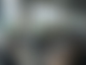 Four engineers in an office with multiple monitors, discussing code. 