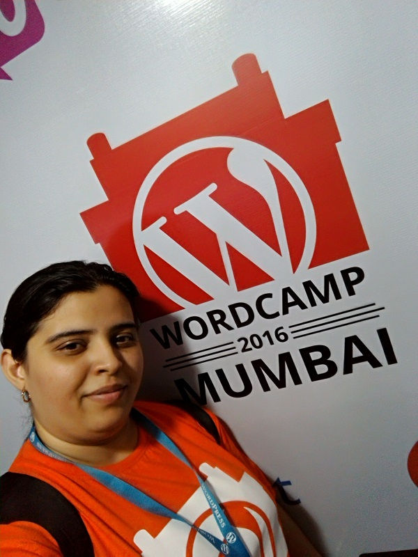 Meher pictured with the WordCamp Mumbai 2016 sign