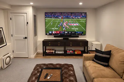 Tilt mount TV installation with soundbar in Harrison New York living room.