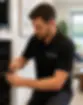 AV technician repairing home audio and automation system in a Charlotte NC living space