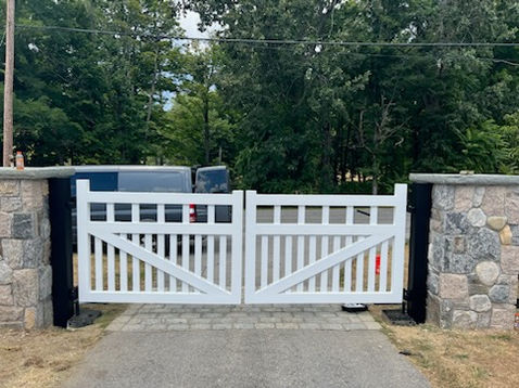 Residential driveway entrance with stone columns at a property in Scarsdale NY