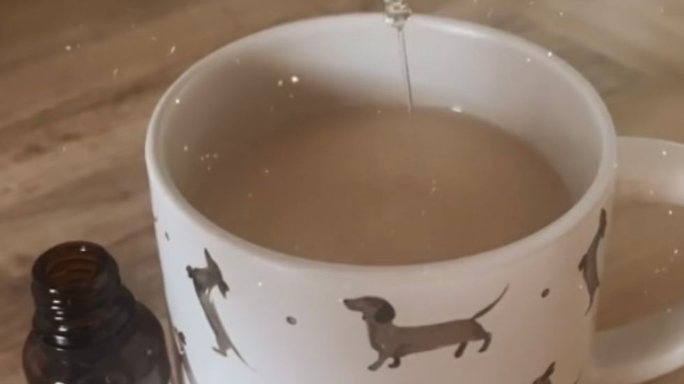 Placenta tincture being dropped into a cup of tea